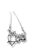 Silver owl family necklace on a white background