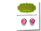 Pink rose earrings on a white card with Janine's Jewelry Design logo.