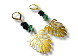 Gold leaf earrings with green beads on a white background