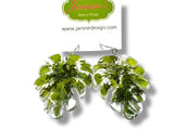Green leaf-shaped earrings on a white background with 'Janine's Jewelry Design' branding.