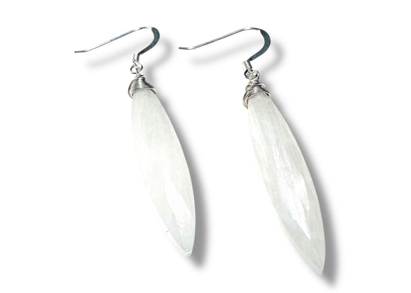 White teardrop-shaped earrings on a white background