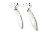 White teardrop-shaped earrings on a white background