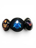 A black three-piece body jewelry set featuring three circular plugs with colorful fantasy designs: a glowing blue dragon in the center, a golden bird on the left, and a purple butterfly on the right, set against a plain white background.
