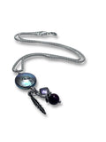 Necklace with Coin pearl pendant, feather and amethyst charm pendant on a white background