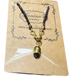 Necklace with a green pendant on a Jantine's Jewelry card