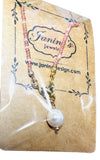 Necklace with pink beads and a pearl on a Janin's Jewelry branded card.