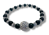 Beaded bracelet with black onyx and silver crystal beads on a white background