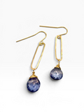 A pair of gold drop earrings with teardrop-shaped dark blue lapis lazuli stones, shown on a clean white background.