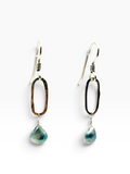 A pair of dangling earrings with irregular dark brown and black open oval hoops, silver-tone wire-wrapping, and faceted light blue-green teardrop gemstones, shown on a clean white background.