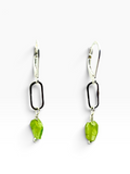 A pair of drop earrings featuring a silver lever-back hook, a black oval link, and a faceted peridot green gemstone dangle, shown on a clean white background.