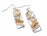 Pair of earrings with natural stone beads on a white background