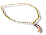 Gold necklace with a crescent-shaped pearl pendant on a white background