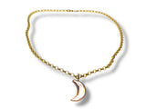 Gold chain necklace with a crescent moon pendant on a white background