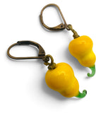 A pair of dangling earrings with glossy yellow pear-shaped drops and green curved tips, attached to antique bronze leverback hooks, shown on a white background.