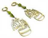 Peridot Plant Earrings. Gold earrings with leaf designs and green beads on a white background