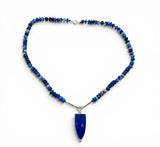 Necklace with blue beaded chain and pendant on a white background