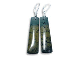 Pair of long, oval-shaped earrings with a natural stone pattern on a white background