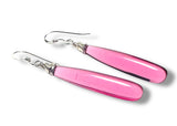 Pink earrings with silver hooks on a white background