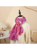 Mannequin wearing a pink scarf with a blurred indoor setting