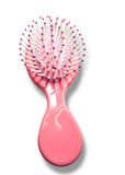 Pink hairbrush with clear handle on a white background