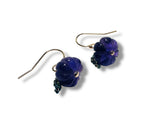 Pair of blue flower-shaped earrings on a white background