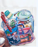 Colorful stationery set in a glass jar design on a white background