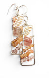 Earrings with multicolored beads and shell elements on a white background