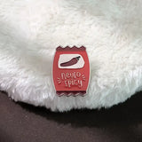 Enamel pin with 'neuro spicy' design on a fluffy white surface