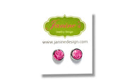 Pink rose earrings on a white card with Janine Jewelry Design logo.