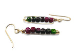 Pair of gold earrings with green and red gemstones on a white background. Ruby Zoisite Bar Earrings
