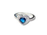 Sapphire Heart Ring, Heart-shaped ring with a blue gemstone on a white background