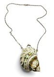 Shell pendant on a chain against a white background