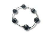 Silver bracelet with black bead accents on a white background