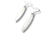 Clear crystal feather-shaped earrings on a white background