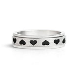Silver ring with black heart shapes on a white background