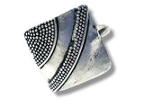 Silver ring with textured design on a white background