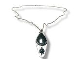 Silver necklace with a pendant on a white background