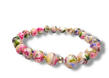 Colorful beaded bracelet with floral patterns on a white background