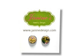 Pair of round earrings with gemstones on a white background with Janine's Jewelry Design logo.