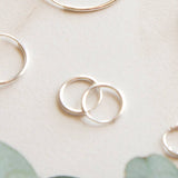 Silver hoop earrings on a light background