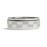 Silver ring with checkered pattern on a white background
