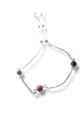 Necklace with purple beads on a white background