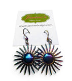 Sun-shaped earrings on a Janine's Jewelry Design card with a white background