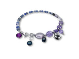 Bracelet with purple and blue beads on a white background. Tanzanite and Amethyst charm bracelet-pearls