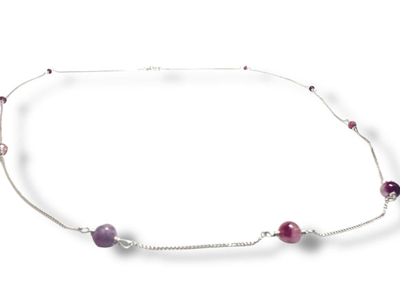 Necklace with purple beads on a white background