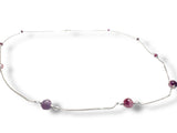Necklace with purple beads on a white background