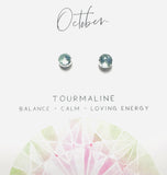 Pair of gemstone earrings labeled 'Tourmaline' with energy attributes on a white background