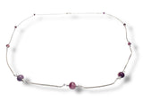 Necklace with purple beads on a white background