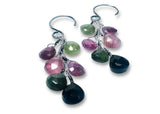 Multicolored gemstone earrings on a white background
