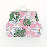 Floral patterned pouch with white lilies and green leaves on a pink background